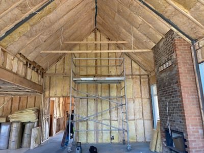 Glasswool batts fitted neatly between ceiling joists in a residential roof cavity