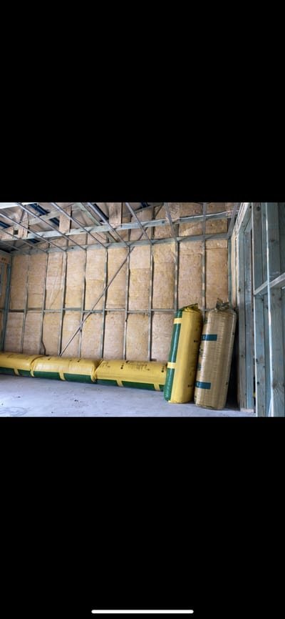 High-density acoustic batts fitted into an internal wall between bedrooms